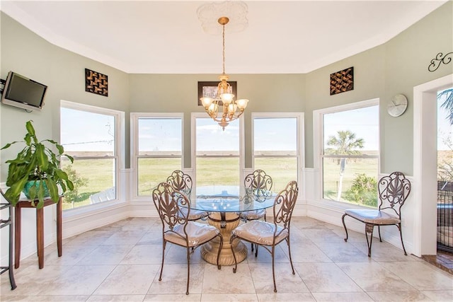 dining area featuring a chandelier and baseboards