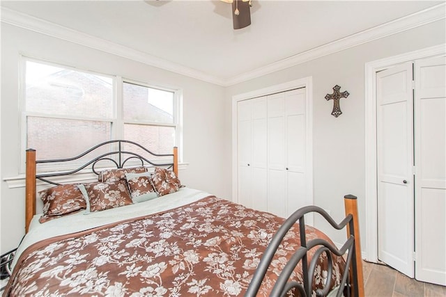 bedroom with wood finished floors, a closet, crown molding, and a ceiling fan