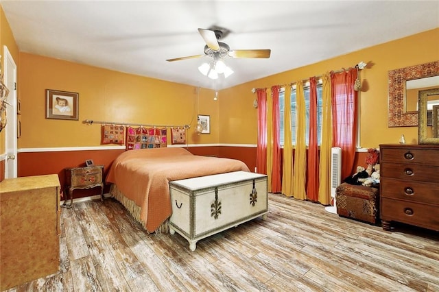 bedroom with wood finished floors and a ceiling fan