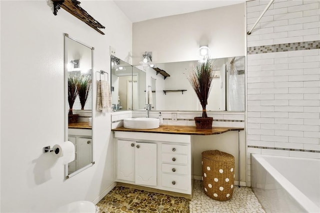 full bath featuring a bath, vanity, and a shower