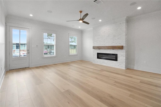 unfurnished living room with ceiling fan, light wood-style floors, a fireplace, and recessed lighting
