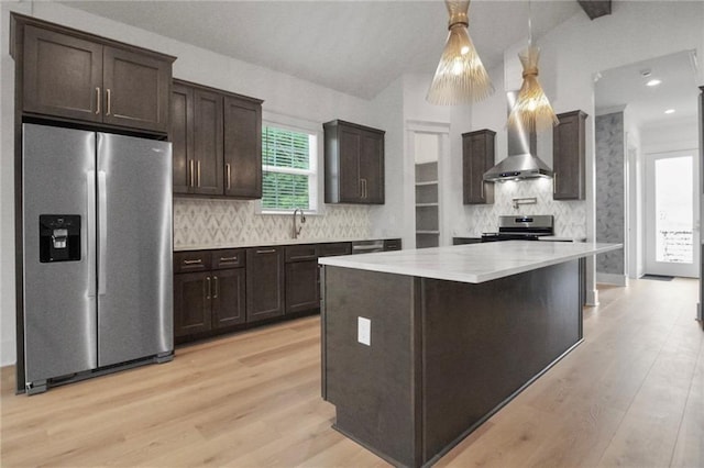 kitchen with stainless steel appliances, dark brown cabinets, light countertops, decorative backsplash, and vaulted ceiling