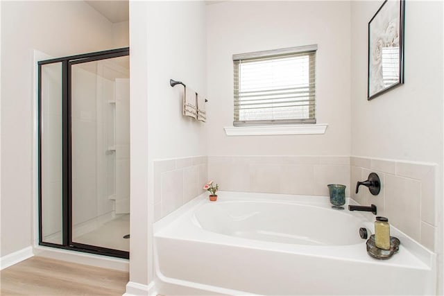 20452 Cornerstone Rd, Hammond, LA 70401 - bathroom featuring a stall shower, a garden tub, and wood finished floors