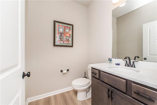 20452 Cornerstone Rd, Hammond, LA 70401 - bathroom with wood finished floors, toilet, vanity, and baseboards