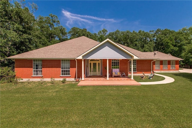 412 Magnolia Ln, Slidell, LA 70461 - back of property with brick siding, a lawn, and french doors