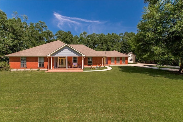 412 Magnolia Ln, Slidell, LA 70461 - rear view of house with brick siding, a lawn, and covered porch