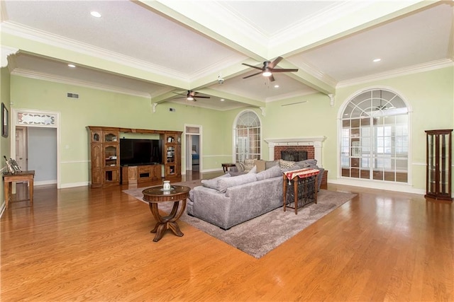 412 Magnolia Ln, Slidell, LA 70461 - living room featuring a fireplace, ceiling fan, wood finished floors, beamed ceiling, and baseboards