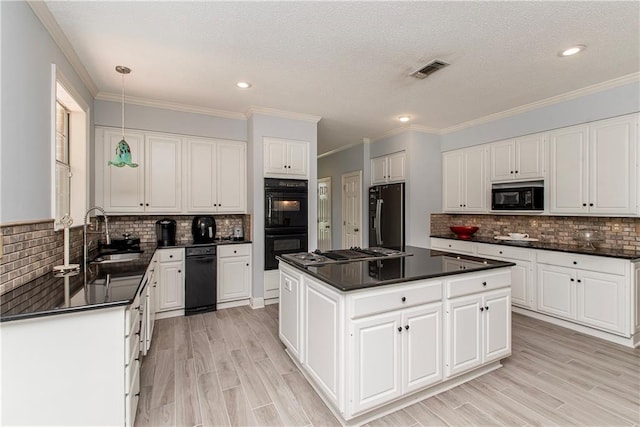 412 Magnolia Ln, Slidell, LA 70461 - kitchen featuring black appliances, a sink, dark countertops, decorative backsplash, and a center island