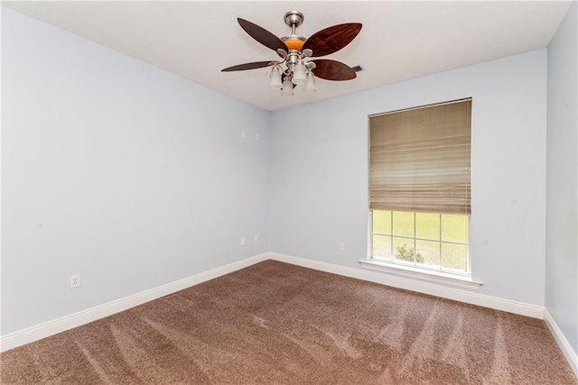 412 Magnolia Ln, Slidell, LA 70461 - spare room featuring dark colored carpet, a ceiling fan, and baseboards