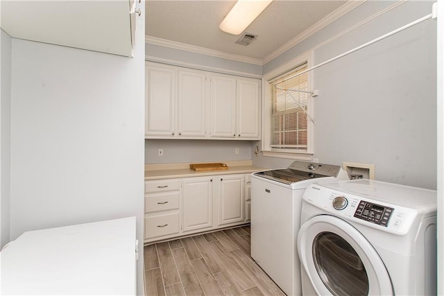 412 Magnolia Ln, Slidell, LA 70461 - washroom featuring washer and dryer, wood tiled floors, ornamental molding, and cabinet space