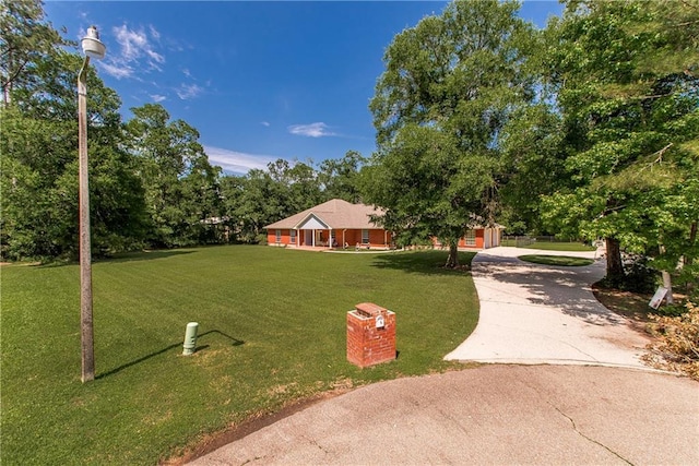 412 Magnolia Ln, Slidell, LA 70461 - view of front of home featuring a front lawn, concrete driveway, and view of scattered trees