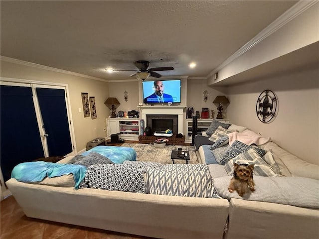 living room with ceiling fan, a brick fireplace, and ornamental molding