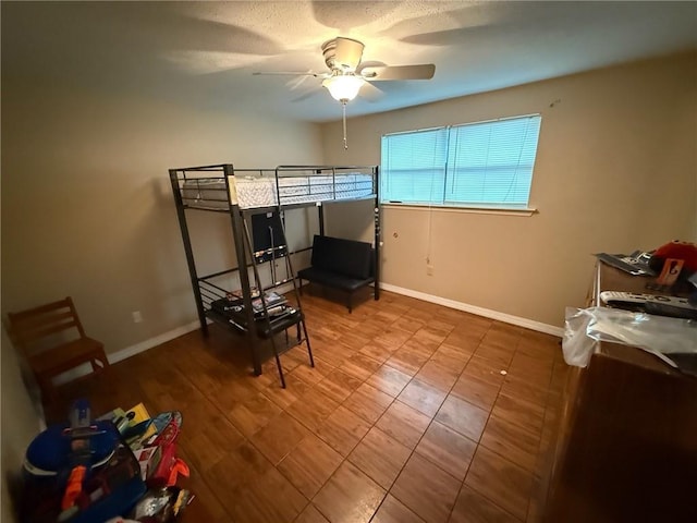 bedroom with baseboards and a ceiling fan