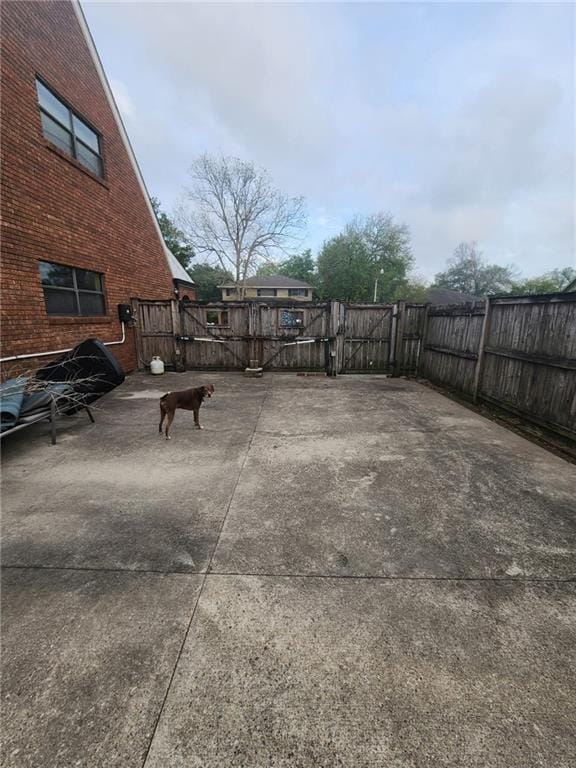view of patio featuring a gate and fence