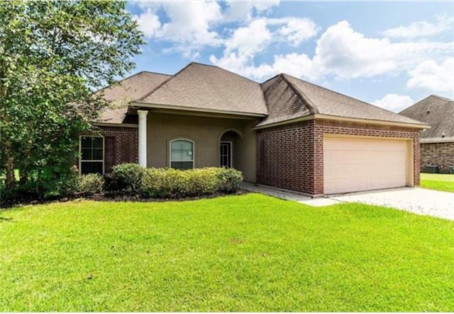 42448 Blythwood Blvd, Ponchatoula, LA 70454 - view of front of home with an attached garage, driveway, a front lawn, and brick siding