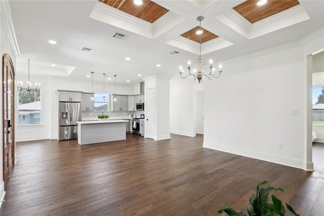 3016 Pecan Dr, Chalmette, LA 70043 - unfurnished living room featuring a chandelier, crown molding, coffered ceiling, healthy amount of natural light, and recessed lighting