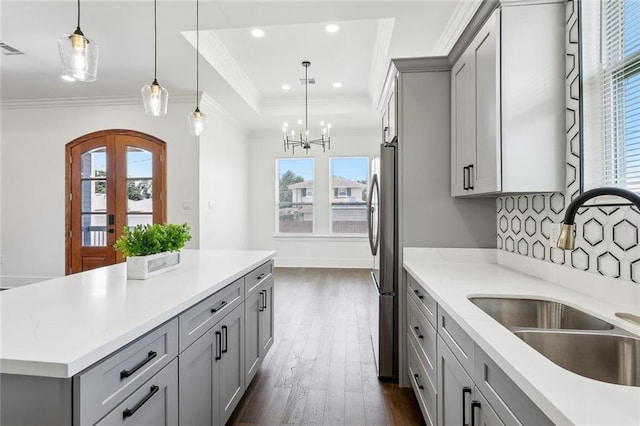 3016 Pecan Dr, Chalmette, LA 70043 - kitchen featuring gray cabinets, a sink, crown molding, dark wood-style flooring, and freestanding refrigerator