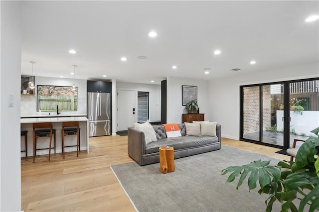 1712 Upperline St, New Orleans, LA 70115 - living area featuring light wood-style floors, healthy amount of natural light, recessed lighting, and french doors