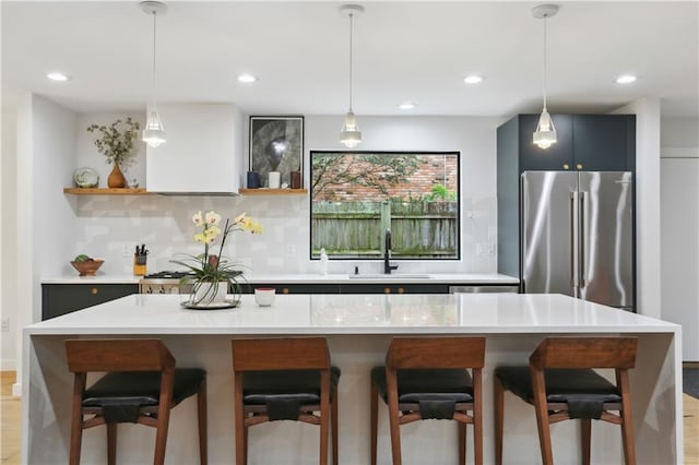 1712 Upperline St, New Orleans, LA 70115 - kitchen featuring a sink, high quality fridge, open shelves, light countertops, and recessed lighting
