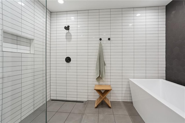 1712 Upperline St, New Orleans, LA 70115 - full bathroom with tile walls, tile patterned flooring, a freestanding bath, and a tile shower