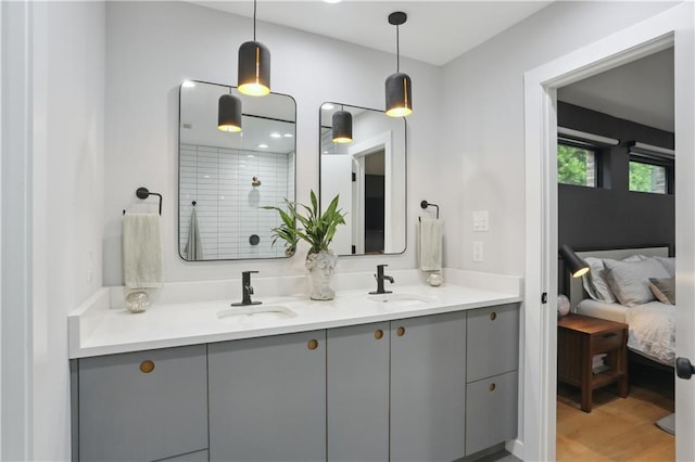 1712 Upperline St, New Orleans, LA 70115 - ensuite bathroom featuring a tile shower, double vanity, and wood finished floors