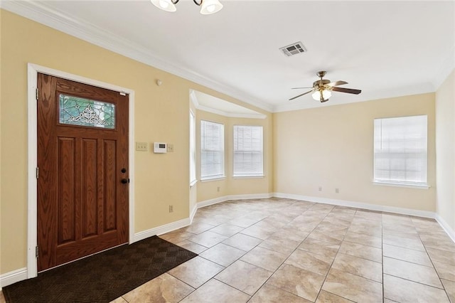 entryway with light tile patterned floors, ornamental molding, ceiling fan, and baseboards