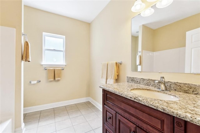 full bathroom featuring baseboards, tile patterned flooring, and vanity