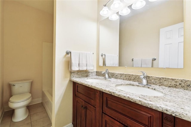 full bath with toilet, double vanity, tile patterned floors, a tub, and baseboards