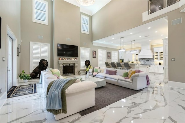 159 Elaine Ave, Harahan, LA 70123 - living area featuring a towering ceiling, baseboards, light marble finish floors, a fireplace, and crown molding