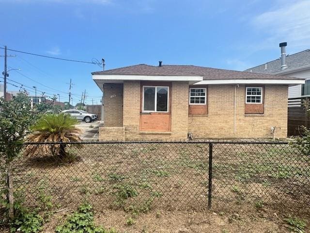 view of home's exterior with brick siding and fence