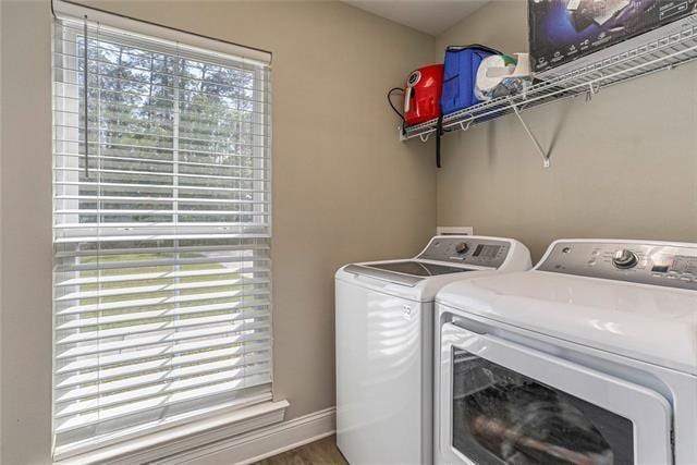 27447 Vela Ln, Lacombe, LA 70445 - clothes washing area featuring washing machine and clothes dryer, wood finished floors, and baseboards