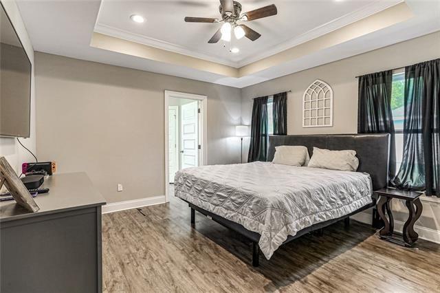27447 Vela Ln, Lacombe, LA 70445 - bedroom featuring a raised ceiling, crown molding, light wood-type flooring, baseboards, and recessed lighting