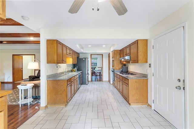 17 S Division Dr, Covington, LA 70433 - kitchen with a ceiling fan, a sink, under cabinet range hood, brown cabinetry, and appliances with stainless steel finishes