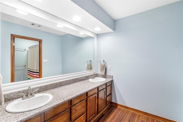 17 S Division Dr, Covington, LA 70433 - full bath with baseboards, wood finished floors, double vanity, recessed lighting, and a shower with curtain