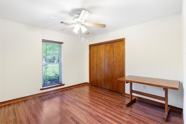 17 S Division Dr, Covington, LA 70433 - unfurnished bedroom featuring wood finished floors, baseboards, a closet, and a ceiling fan