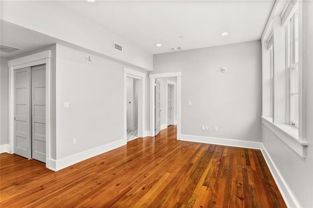 1215 Louisiana Ave Unit 105, New Orleans, LA 70115 - unfurnished bedroom featuring hardwood / wood-style flooring, baseboards, and recessed lighting