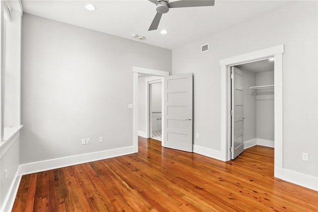 1215 Louisiana Ave Unit 105, New Orleans, LA 70115 - unfurnished bedroom featuring hardwood / wood-style flooring, baseboards, recessed lighting, a spacious closet, and ceiling fan