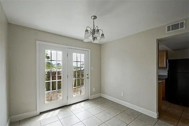 4854 Pontchartrain Dr Unit 3, Slidell, LA 70458 - unfurnished dining area with light tile patterned floors, a chandelier, and baseboards