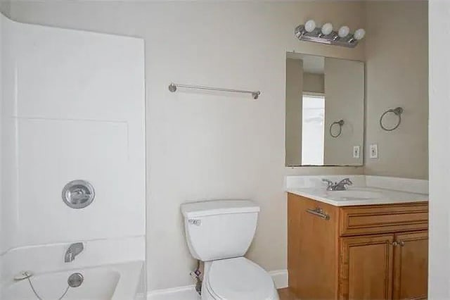 4854 Pontchartrain Dr Unit 3, Slidell, LA 70458 - bathroom featuring vanity, toilet, tub / shower combination, and baseboards