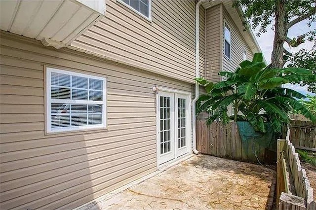 4854 Pontchartrain Dr Unit 3, Slidell, LA 70458 - view of side of home with fence, a patio, and french doors