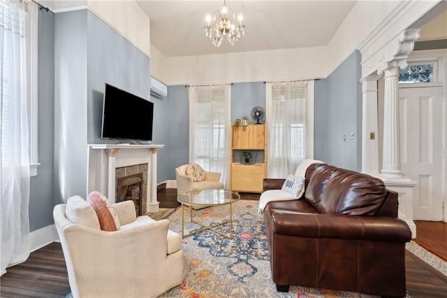 1614 Governor Nicholls St Unit 1, New Orleans, LA 70116 - living area featuring dark wood finished floors, a tiled fireplace, ornate columns, and baseboards
