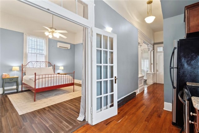 1614 Governor Nicholls St Unit 1, New Orleans, LA 70116 - bedroom with dark wood-style flooring, a wall unit AC, and baseboards