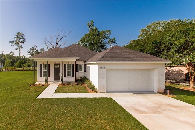 15326 S Tiger Loop, Ponchatoula, LA 70454 - view of front of home with a front lawn, brick siding, concrete driveway, an attached garage, and a shingled roof