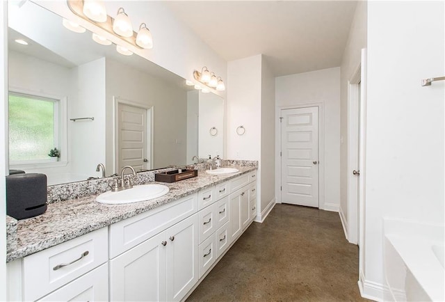 15326 S Tiger Loop, Ponchatoula, LA 70454 - full bathroom featuring double vanity, a tub, concrete flooring, and baseboards