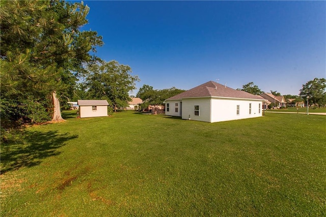 15326 S Tiger Loop, Ponchatoula, LA 70454 - view of grassy yard with an outdoor structure and a storage shed