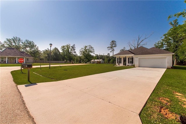 15326 S Tiger Loop, Ponchatoula, LA 70454 - view of front of property featuring driveway, a front lawn, and an attached garage