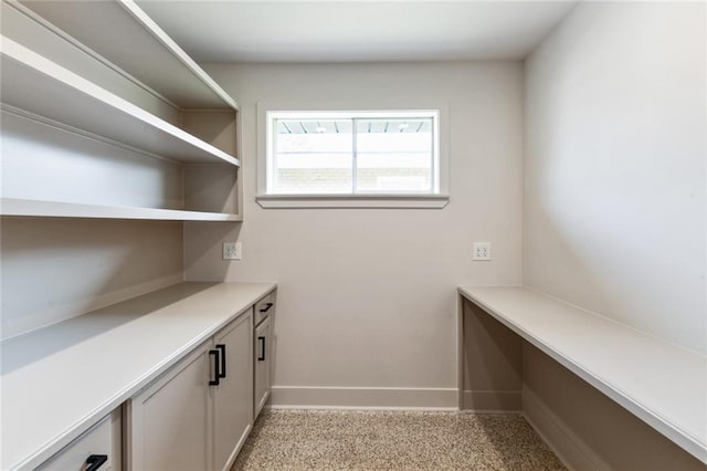 laundry area with baseboards