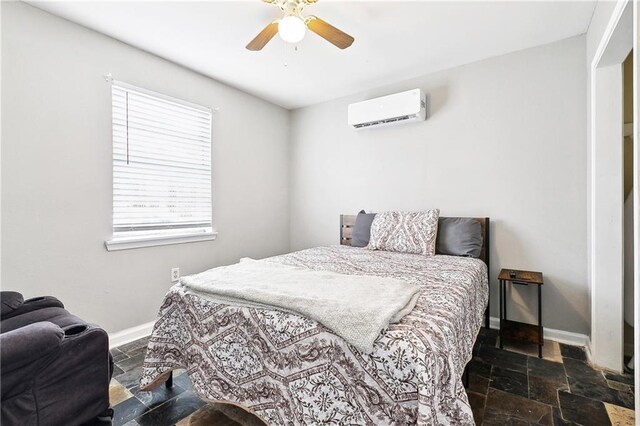 1031 Henriette Delille St Unit 1, New Orleans, LA 70116 - bedroom with a wall mounted AC, stone tile flooring, baseboards, and ceiling fan