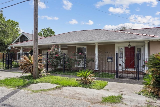 922 Lamanche St, New Orleans, LA 70117 - view of front facade with a fenced front yard, stucco siding, a porch, and a gate