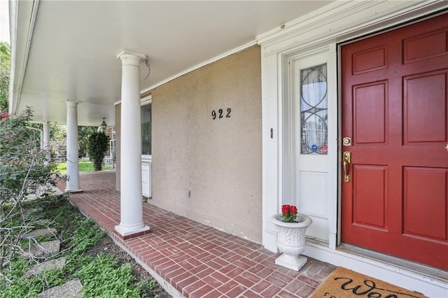 922 Lamanche St, New Orleans, LA 70117 - view of exterior entry featuring covered porch and stucco siding